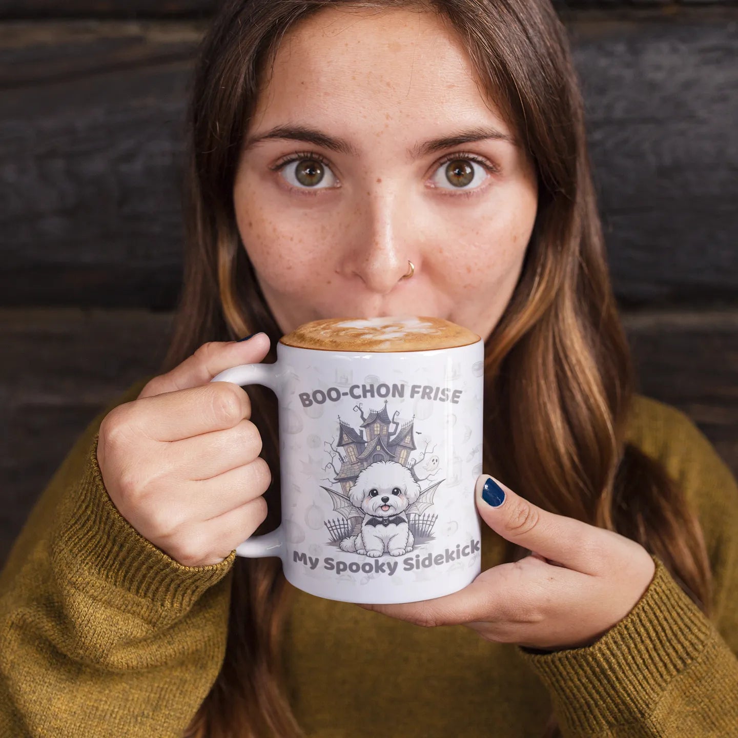 Girl sipping hot chocolate from a white mug featuring a Boo-Chon Frise Halloween design – cozy and spooky mug mockup for dog lovers