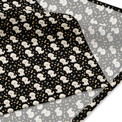 Close-up of black bandana fabric with cute Bichon Frise dog pattern, paw prints, hearts, and bones design
