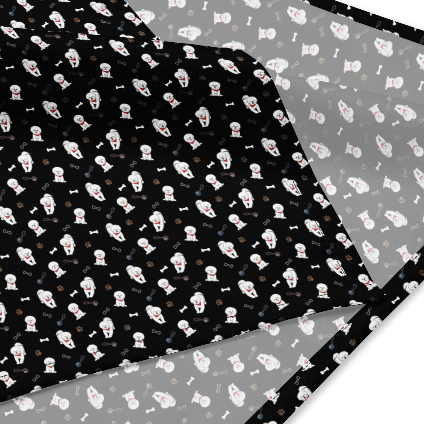 Close-up of black Bichon Frise patterned bandana fabric with playful dog, paw, and bone design
