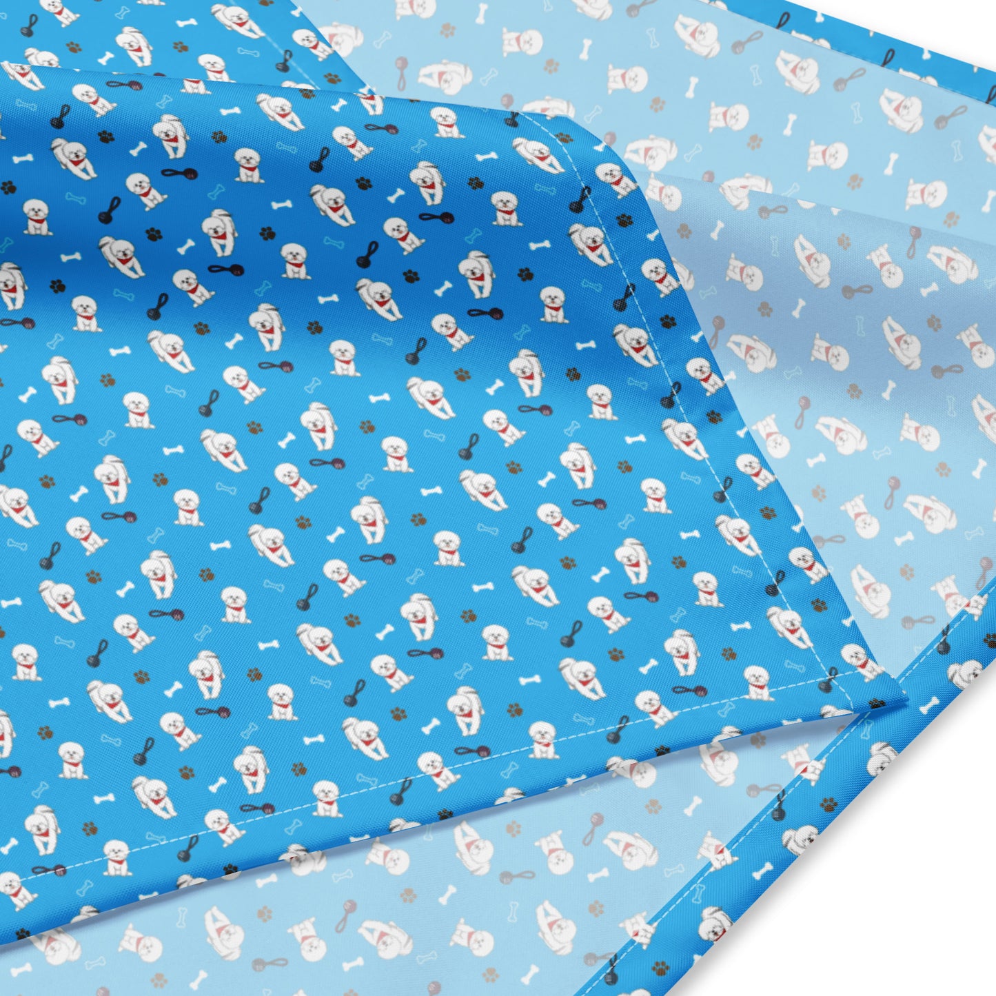 Close-up of blue Bichon Frise patterned bandana fabric with playful dog, paw, and bone design