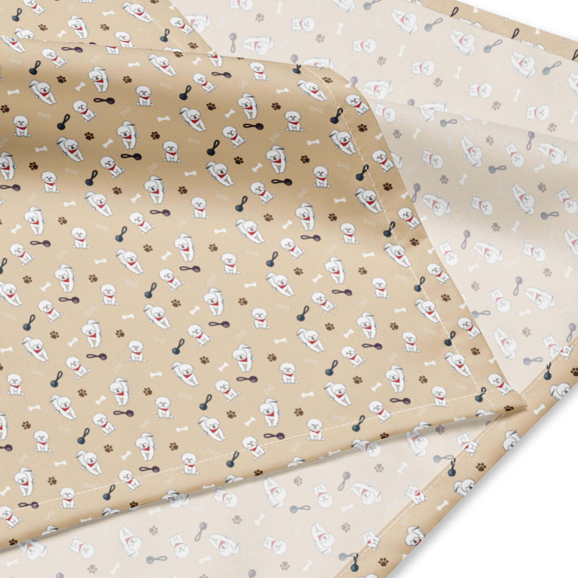 Close-up of beige Bichon Frise patterned bandana fabric with playful dog, paw, and bone design