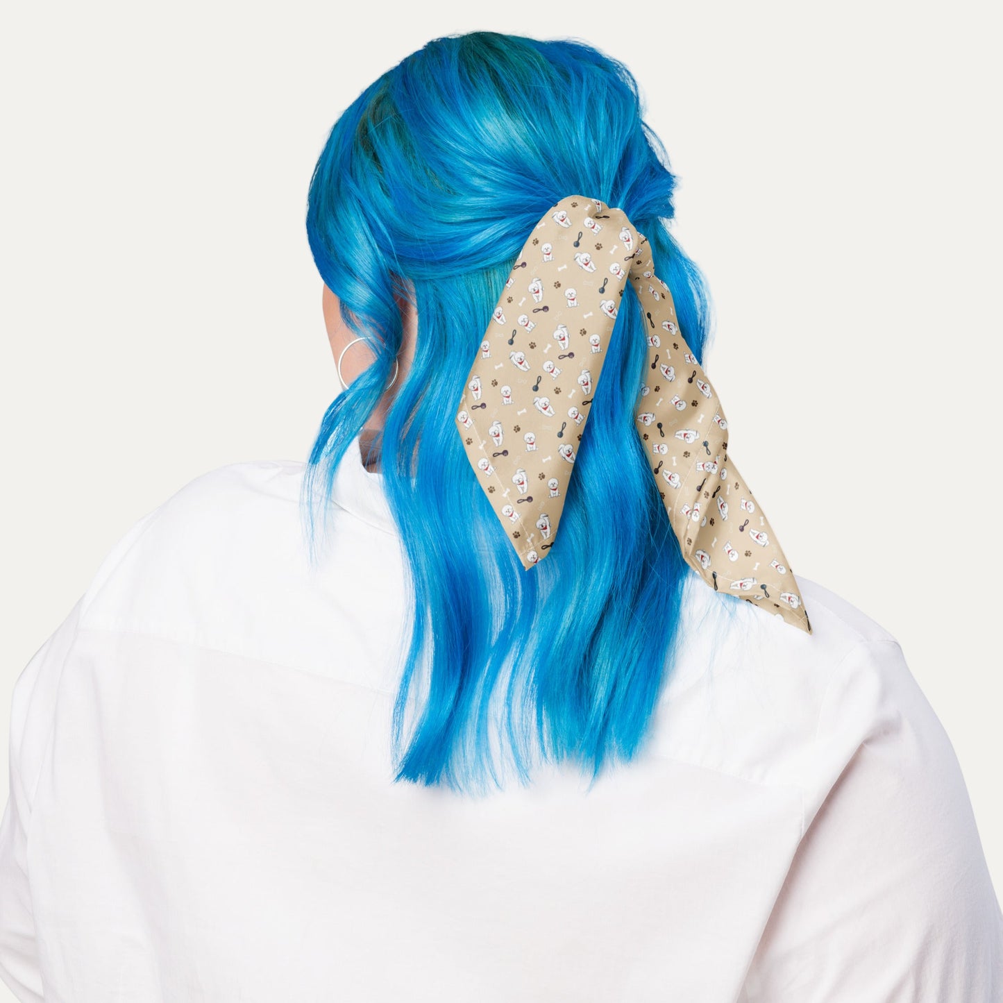 Woman with blue hair wearing beige Bichon Frise patterned bandana as hair accessory