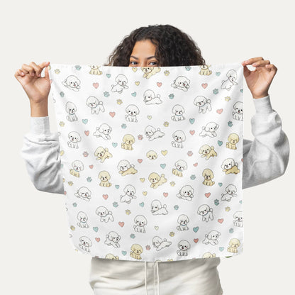 Smiling woman holding up a cream bandana with a cute Bichon Frise, pastel hearts and paw prints pattern – stylish dog lover accessory mockup