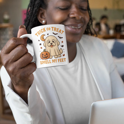 Smiling Black woman holding a white Halloween coffee mug with a Bichon Frise in ghost costume and pumpkin illustration, Trick or Treat Smell My Feet design