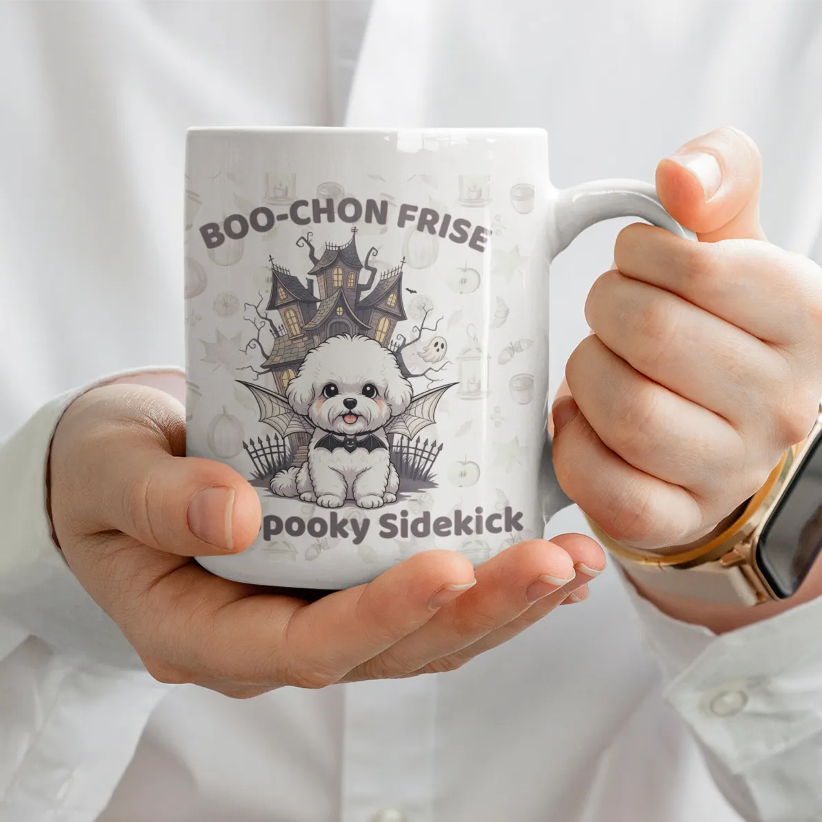 White ceramic mug with a cute Halloween Bichon Frise cartoon and “Boo-chon Frise – My Spooky Sidekick” text, held by a woman in white shirt – funny Halloween gift for dog lovers.