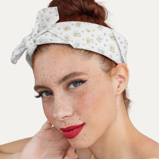 Close-up of a young woman wearing a headband-style bandana with a cute Bichon Frise dog pattern, pastel hearts and paw prints – stylish accessory mockup
