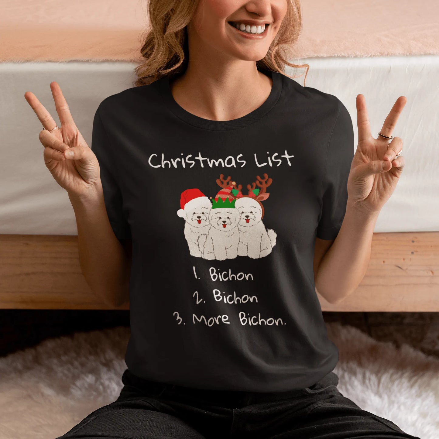 "Funny Christmas-themed unisex t-shirt with text 'Christmas List: 1. Bichon 2. Bichon 3. More Bichon' – perfect holiday gift for dog lovers, especially Bichon Frisé owners; cheerful and unique dog print shirt for men and women."