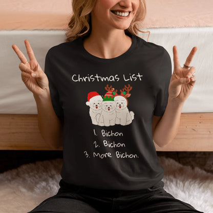 "Funny Christmas-themed unisex t-shirt with text 'Christmas List: 1. Bichon 2. Bichon 3. More Bichon' – perfect holiday gift for dog lovers, especially Bichon Frisé owners; cheerful and unique dog print shirt for men and women."