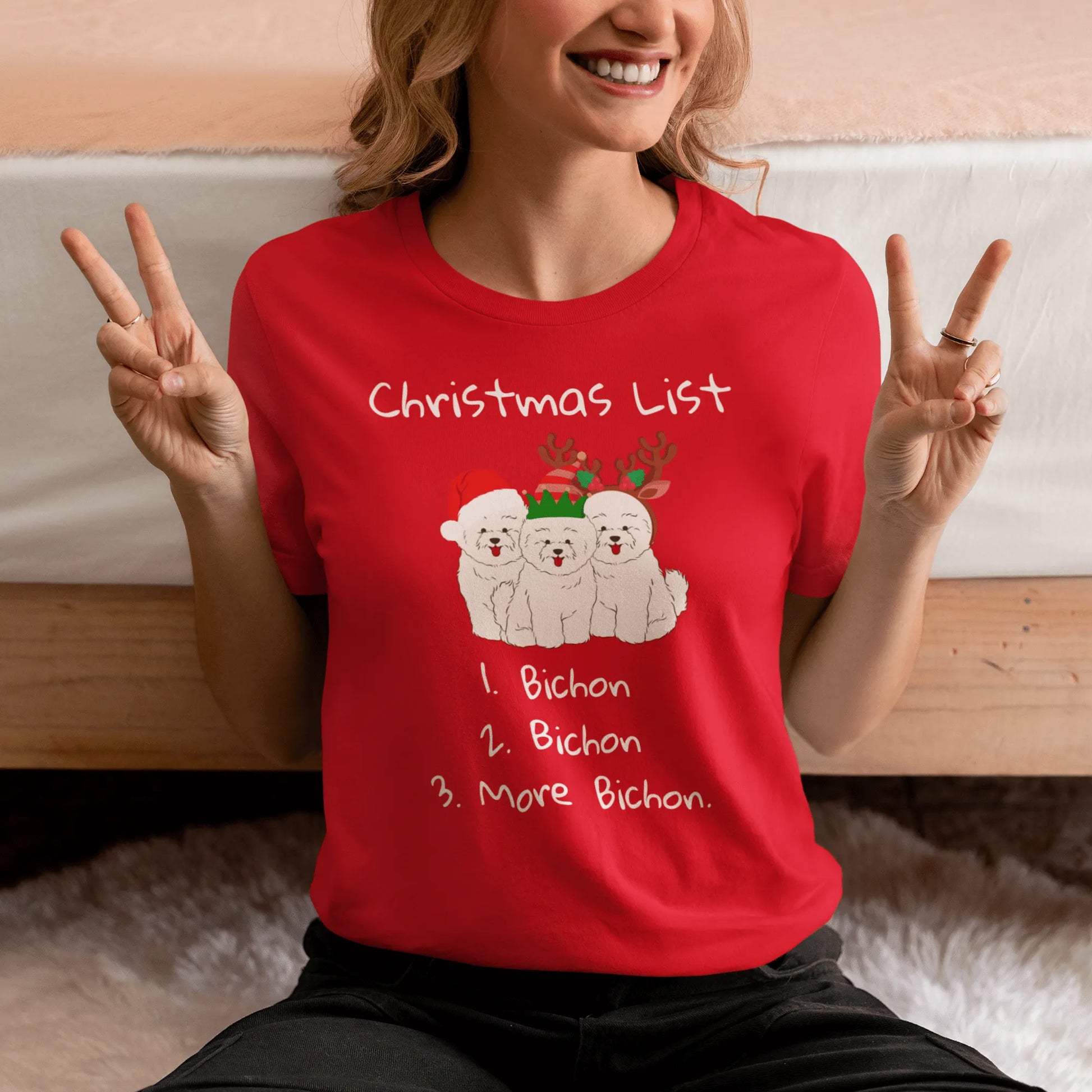 "Funny Christmas-themed unisex t-shirt with text 'Christmas List: 1. Bichon 2. Bichon 3. More Bichon' – perfect holiday gift for dog lovers, especially Bichon Frisé owners; cheerful and unique dog print shirt for men and women."