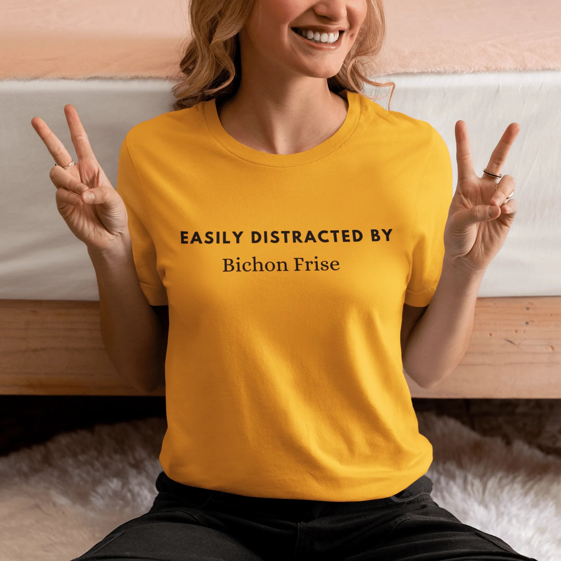 "Black unisex T-shirt with playful text 'Easily distracted by bichon frise' – unique and funny dog lover shirt perfect for Bichon Frise owners and fans. Stylish casual tee for men and women who adore their bichon dogs."