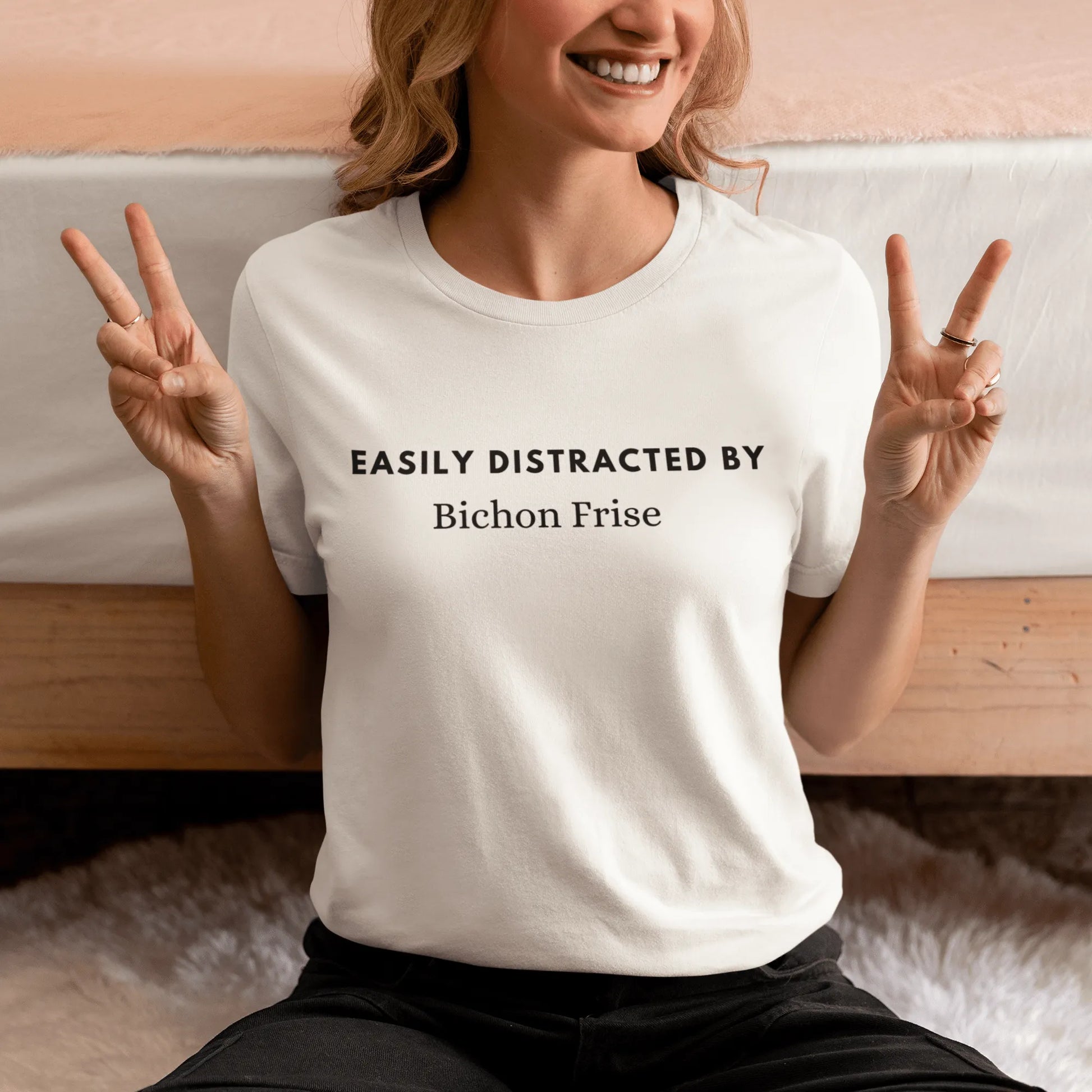 "Black unisex T-shirt with playful text 'Easily distracted by bichon frise' – unique and funny dog lover shirt perfect for Bichon Frise owners and fans. Stylish casual tee for men and women who adore their bichon dogs."