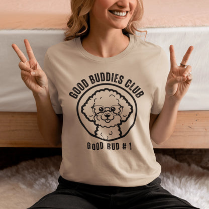 "Good Buddies Club unisex black T-shirt featuring a cheerful, happy Bichon Frise dog illustration wearing glasses, perfect for dog owners and dog lovers. Fun and unique dog-themed shirt design, ideal not only for Bichon Frise fans but all dog enthusiasts."
