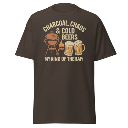 Retro-style graphic design featuring a BBQ grill, two cold beers, flames and the text "Charcoal, Chaos & Cold Beers – My Kind of Therapy" on a vintage Father's Day t-shirt.