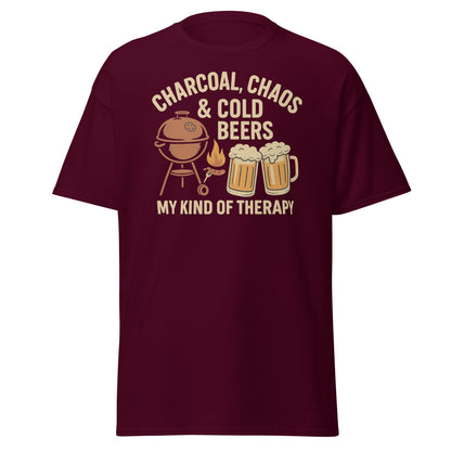 Retro-style graphic design featuring a BBQ grill, two cold beers, flames and the text "Charcoal, Chaos & Cold Beers – My Kind of Therapy" on a vintage Father's Day t-shirt.
